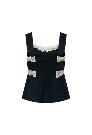 A dark navy blue velvet-like smocked top with wide straps and beige lace trim at the neckline and waist, shown on a plain white background.