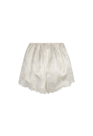 Off-white satin shorts with a subtle floral jacquard pattern and a delicate lace hem, shown against a plain white background.