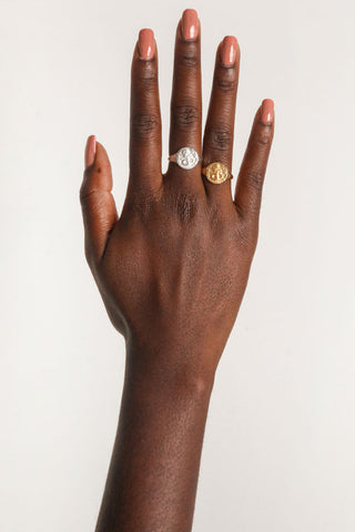 close-up-image-of-a-hand-with-painted-nails-wearing-gold-rings-including-that-of-the-spell-s-stargazer-zodiac-ring